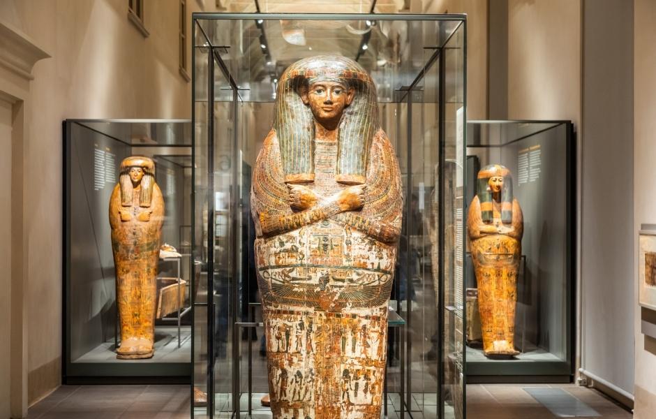Egyptian sarcophagi in glass gallery cases, representing the cultural collections institutions manage with TMS Suite.
