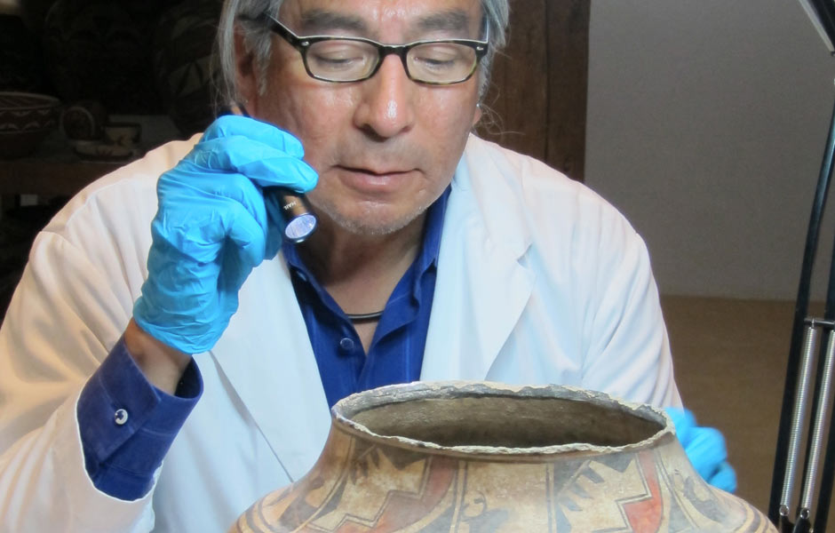 Conservator looking at ceramic piece