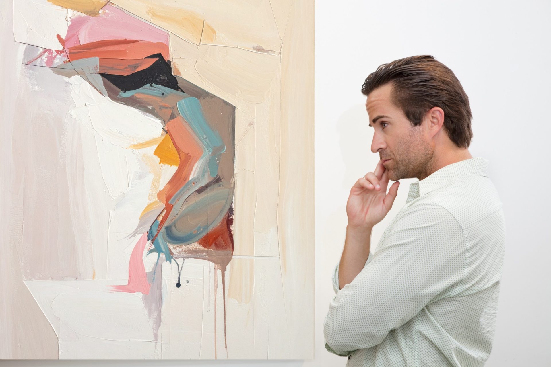 art collector considering an abstract painting.