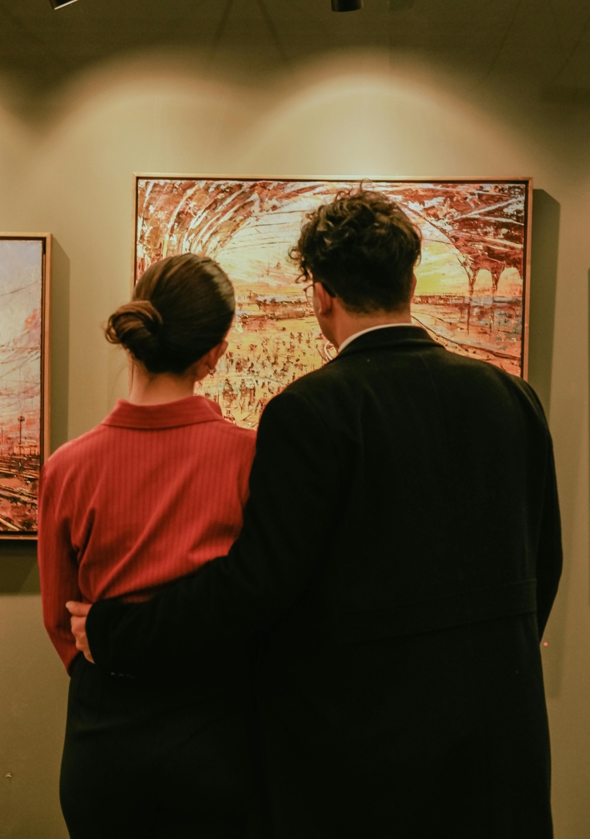 art collectors reviewing a painting.