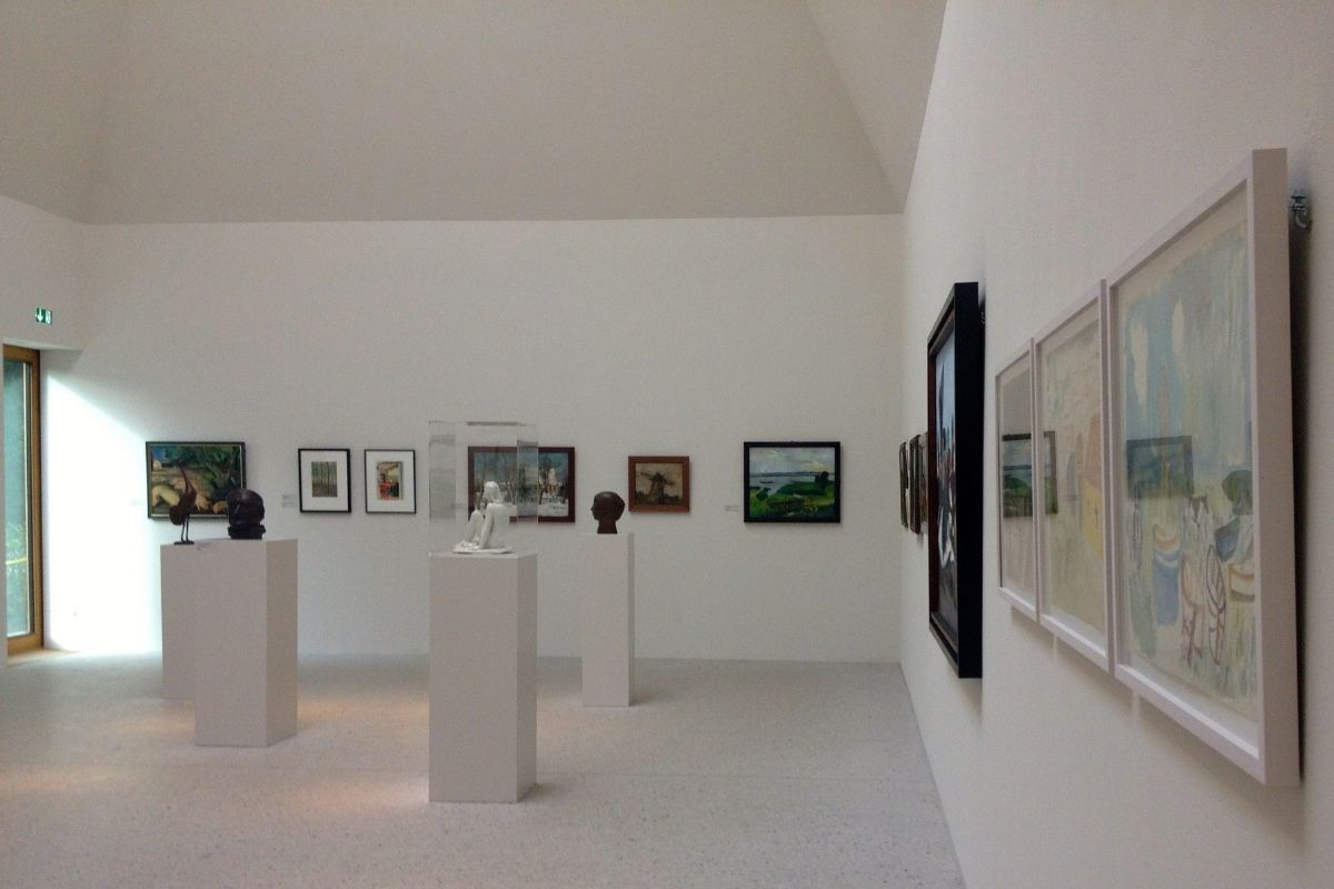 small gallery exhibition with mixed media and multiple artists.