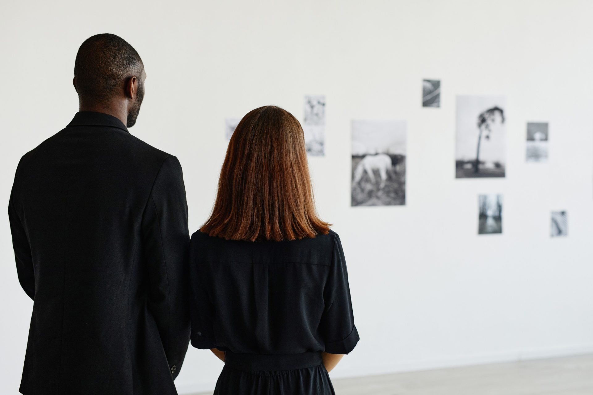couple at a contemporary art gallery looking at black and white photography