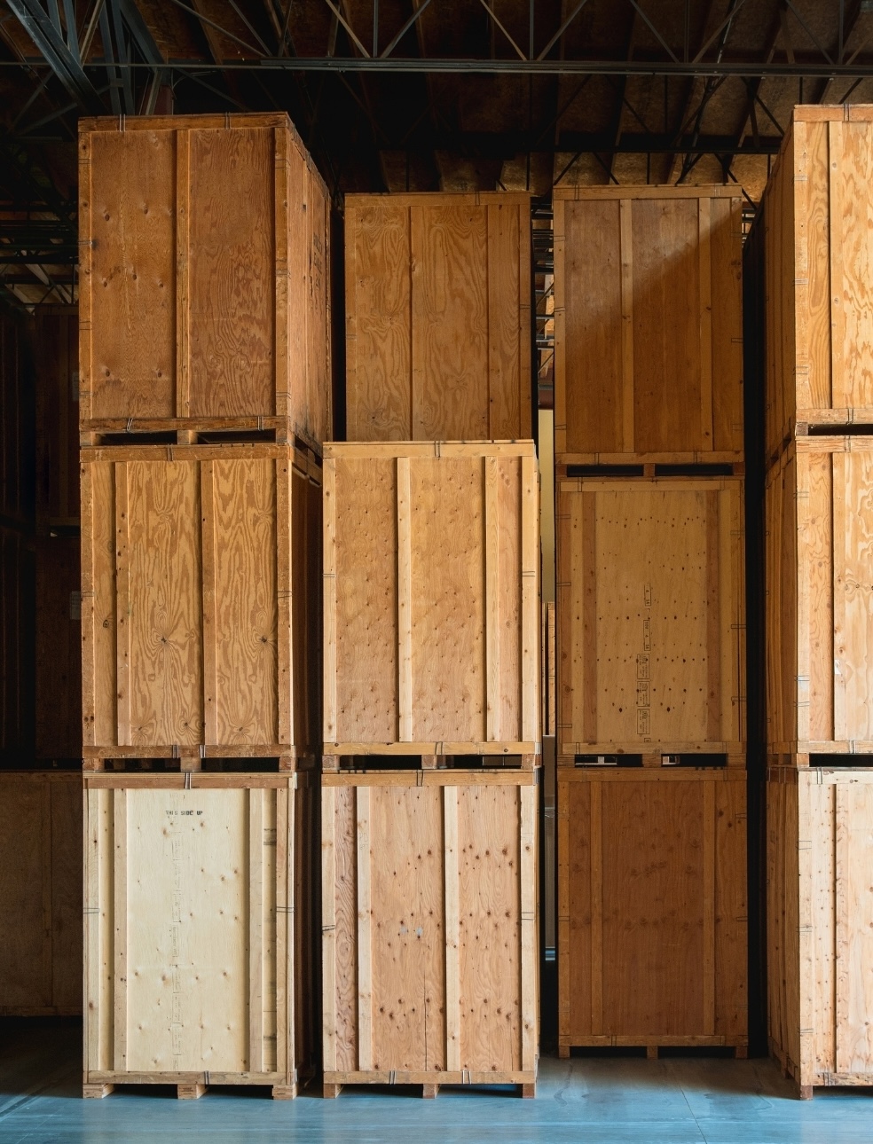 artwork packed into shipping crates and located in a back storage area in a museum.
