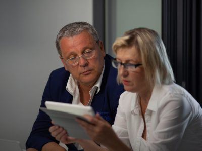 couple looking at their art collection on an ipad.