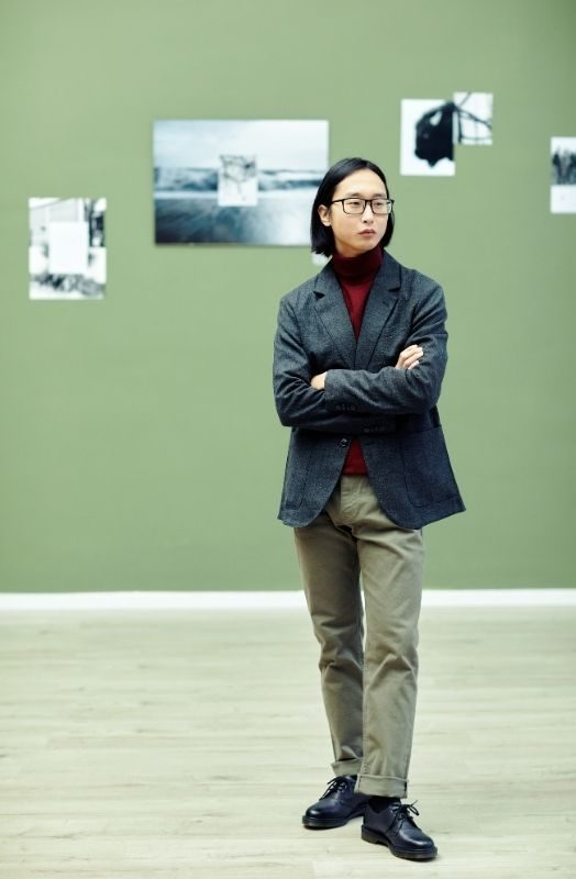 gallery associate standing in an art fair booth.