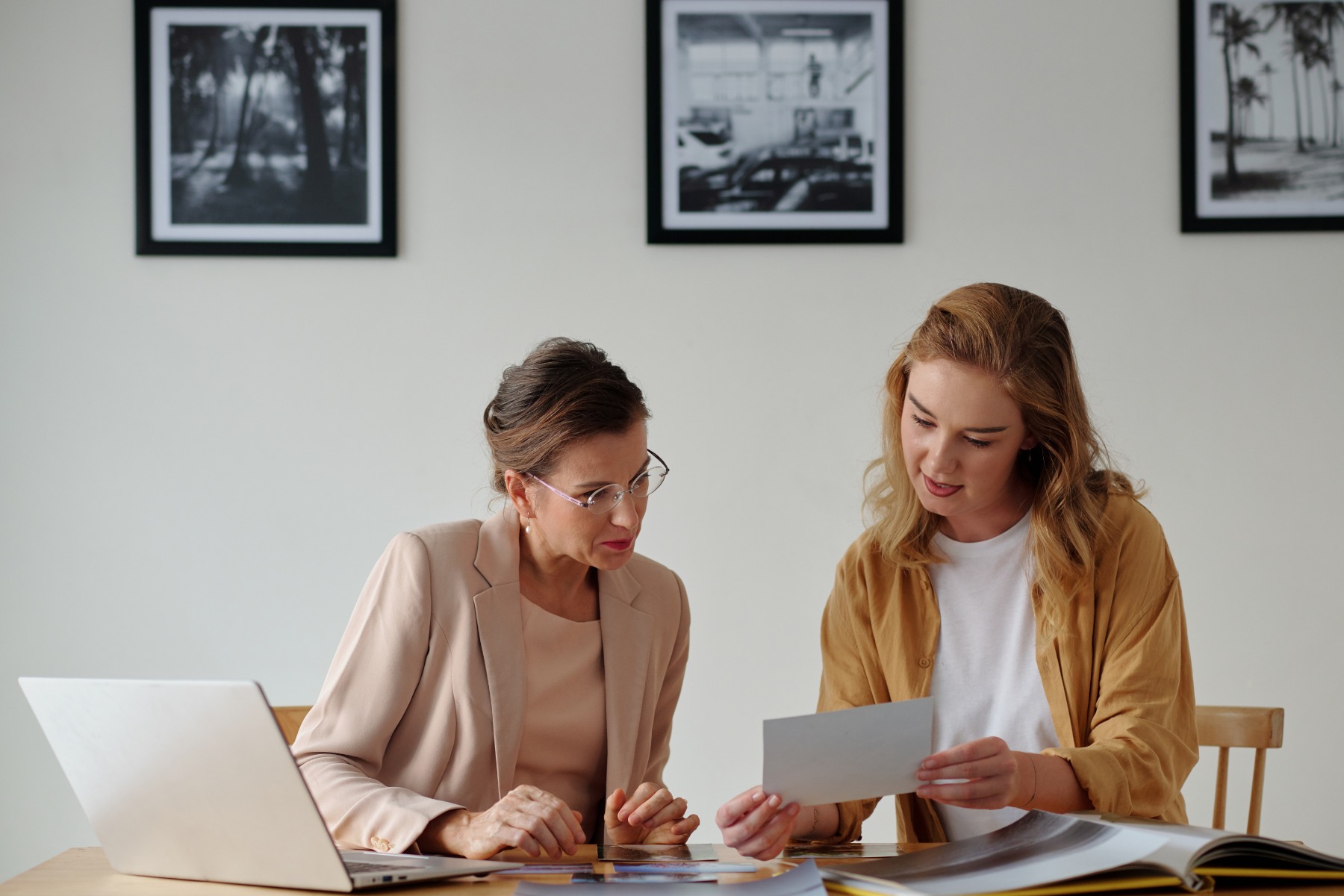 gallerist and her associate working on an exhibition