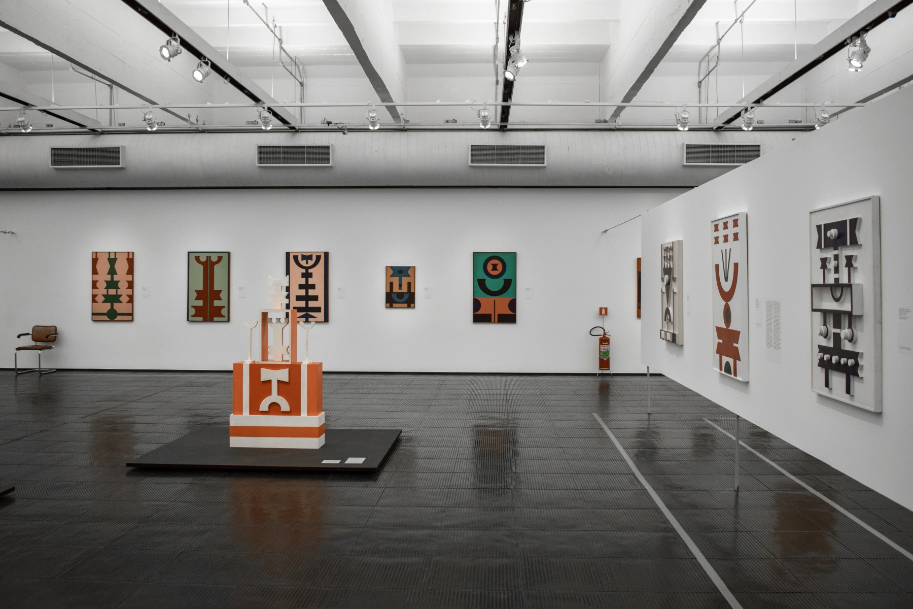 gallery exhibition featuring paintings and sculpture.