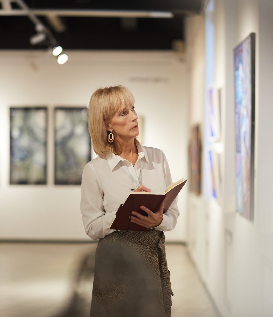 gallery owner taking notes on a current exhibition