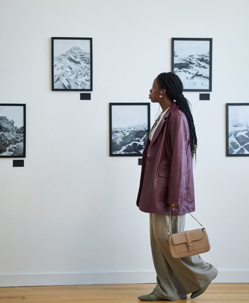 gallery visitor looking at wall of photography
