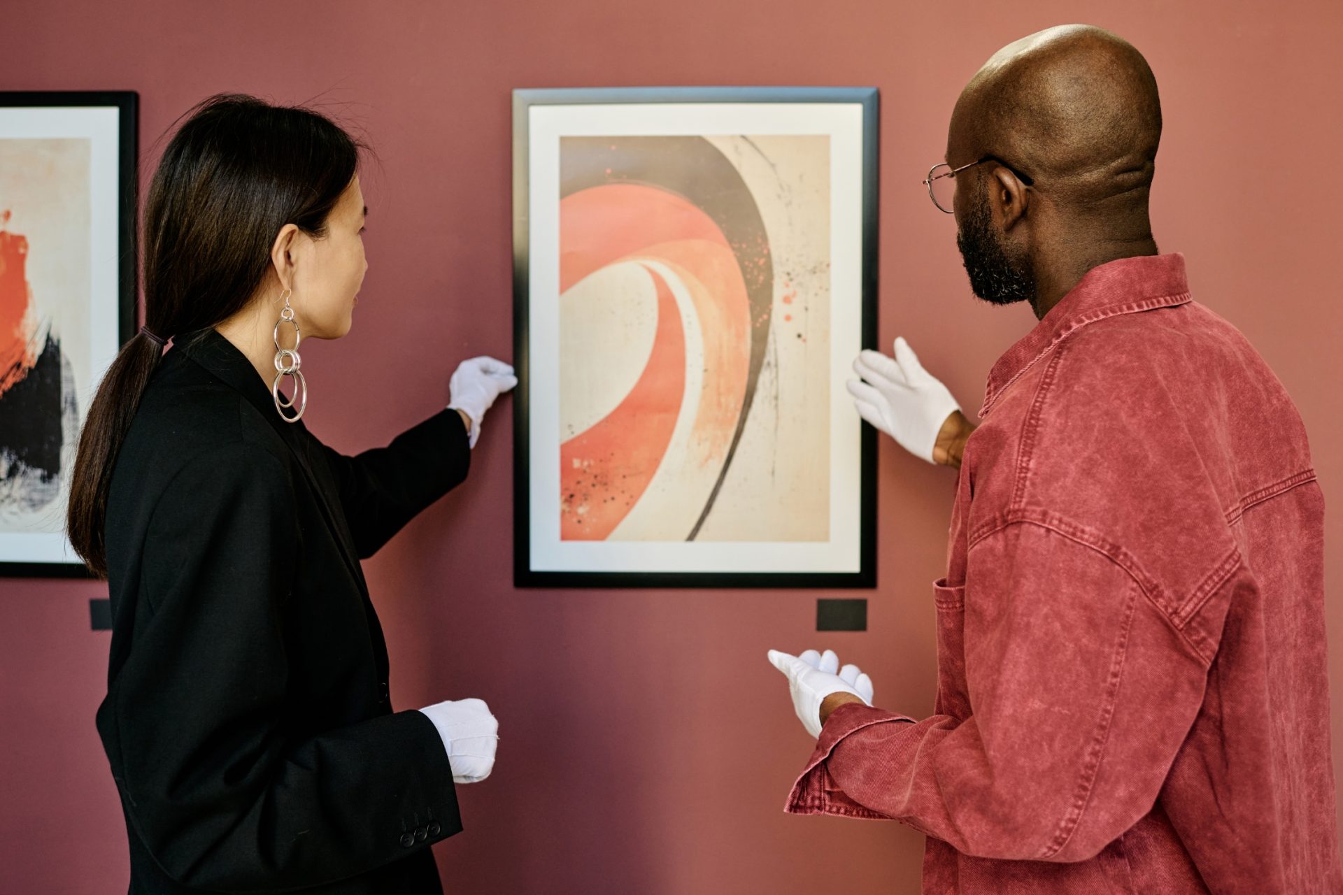 collection managers installing new works in a corporate office.