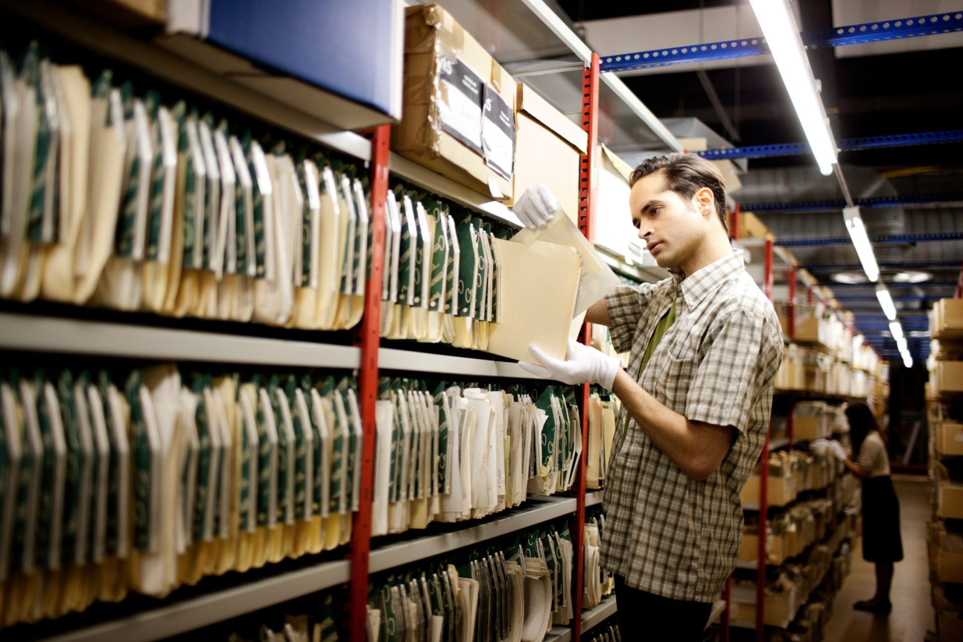 archivist looking for documents in museum storage.