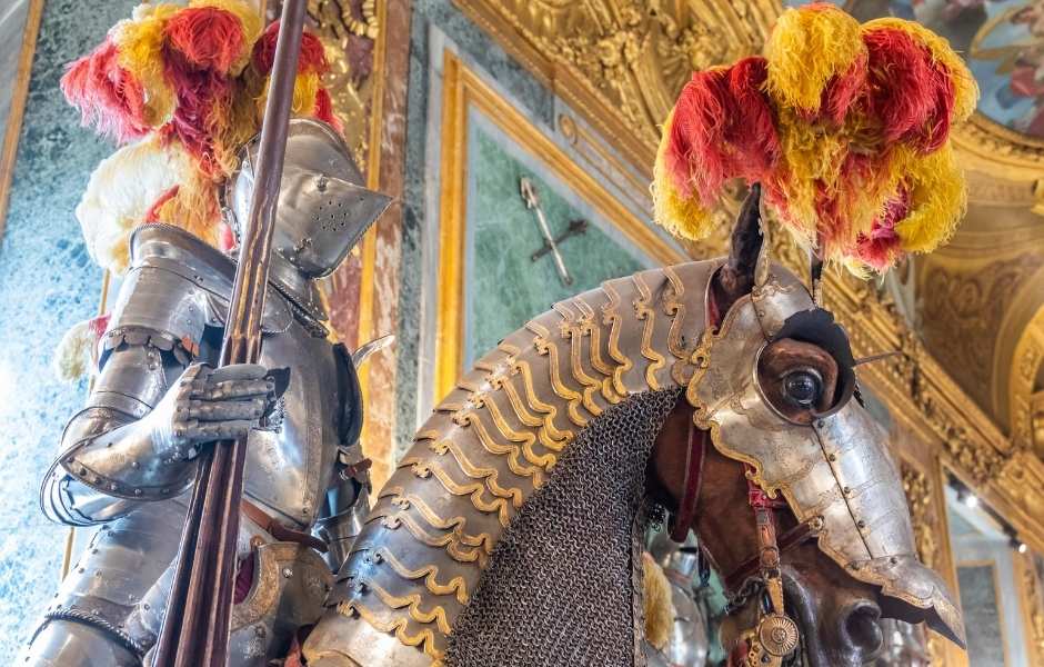 Medieval knight and horse armour on display in a gallery, representing the government and military collections institutions manage with Gallery Systems.
