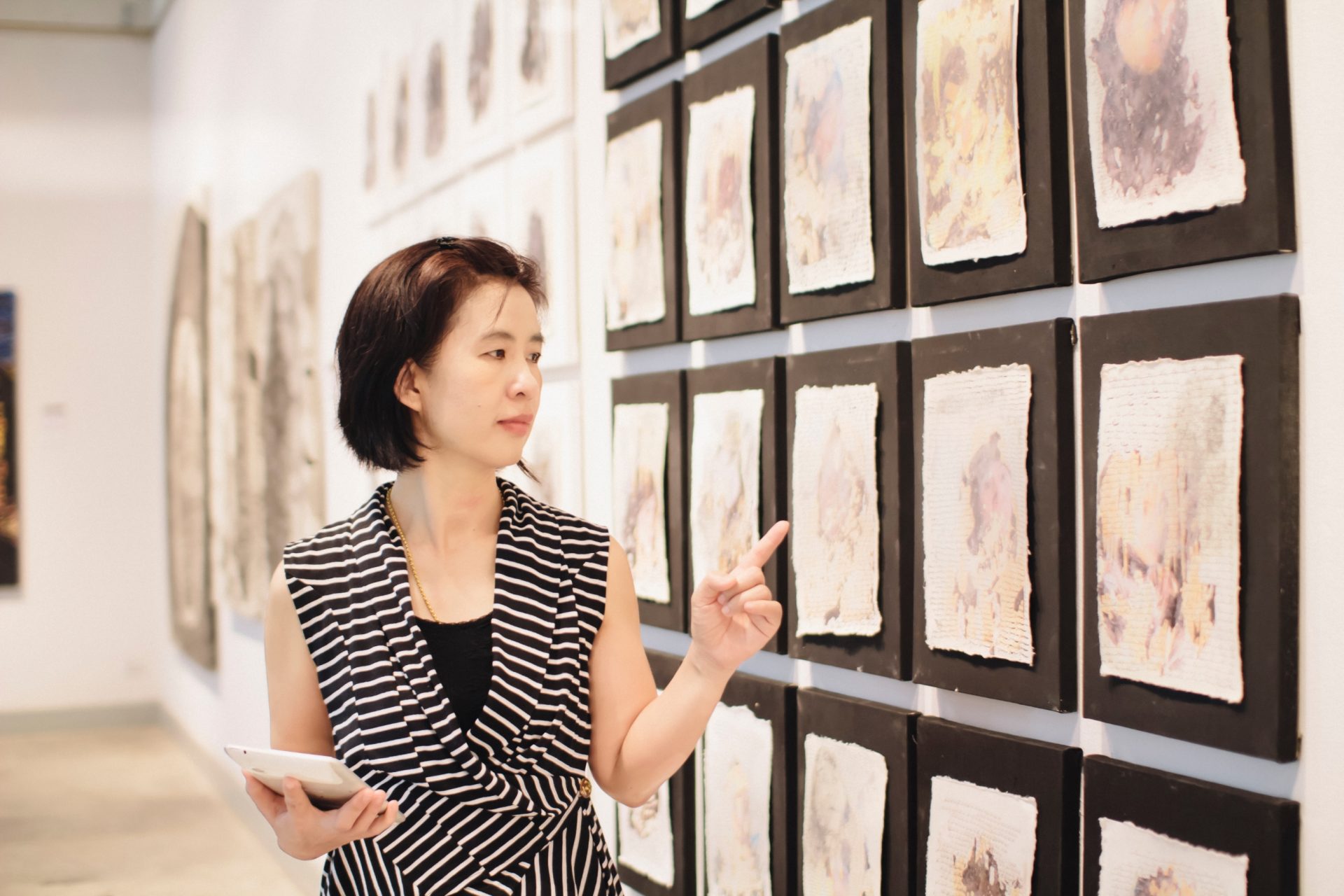 museum curator reviewing new exhibition install before opening.
