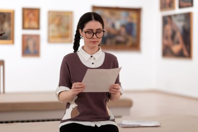 museum curator checking her work list for an exhibiton.