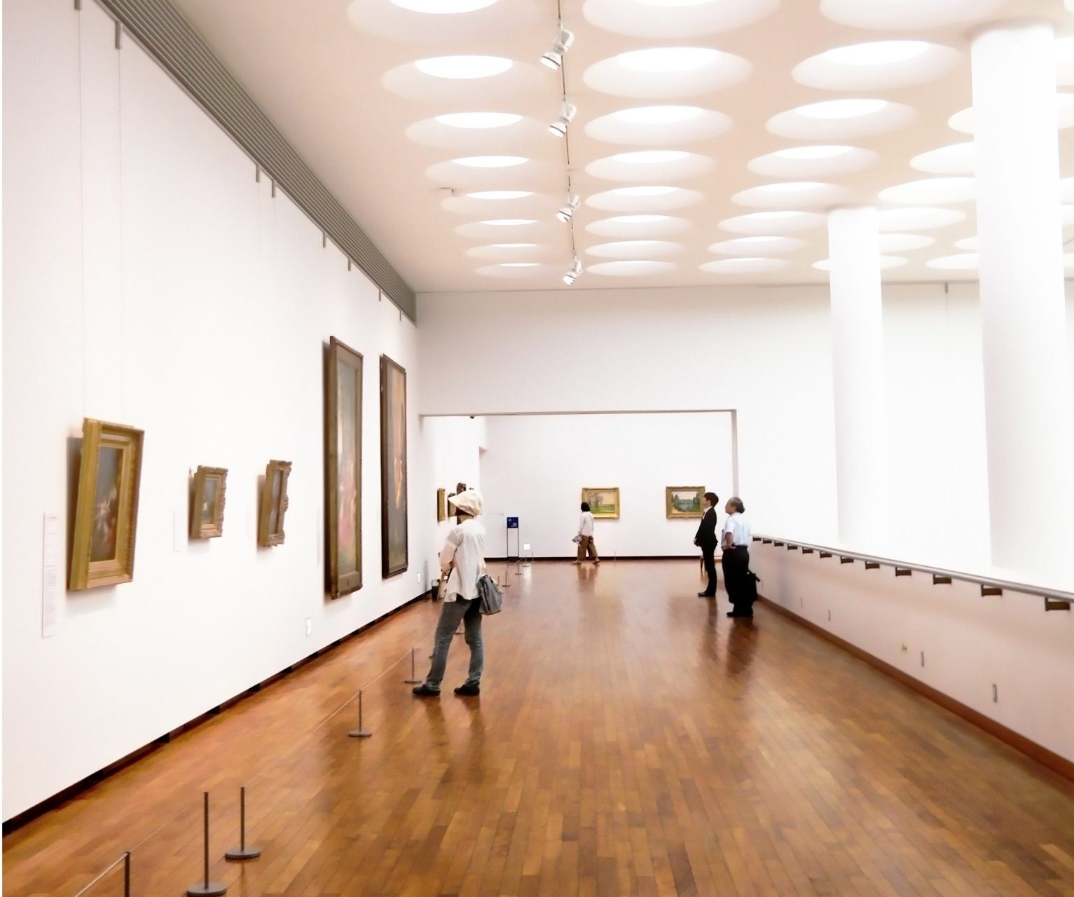 museum exhibition with visitors browsing the art.