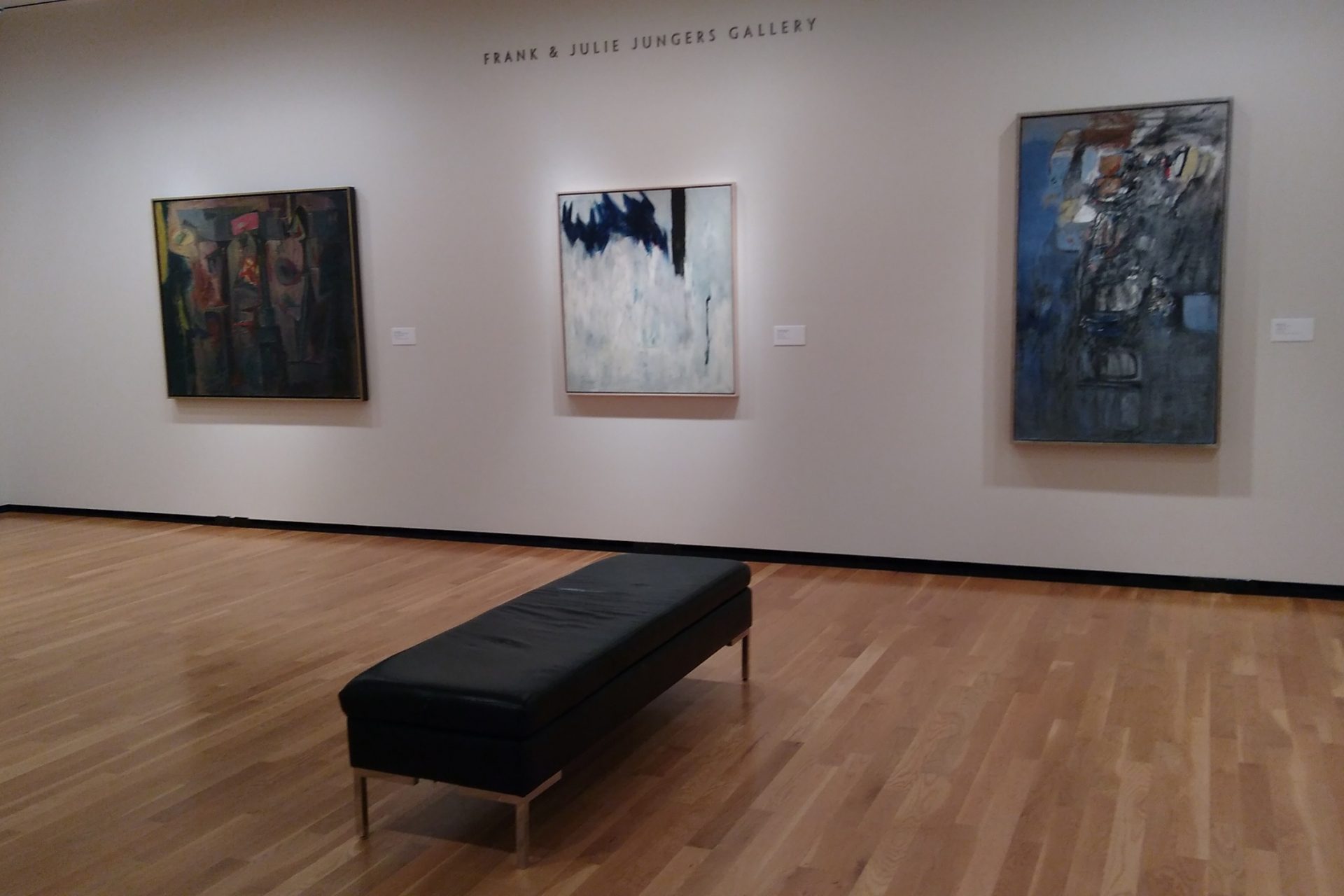 museum exhibition showing paintings.