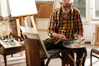 older artist in his painting studio
