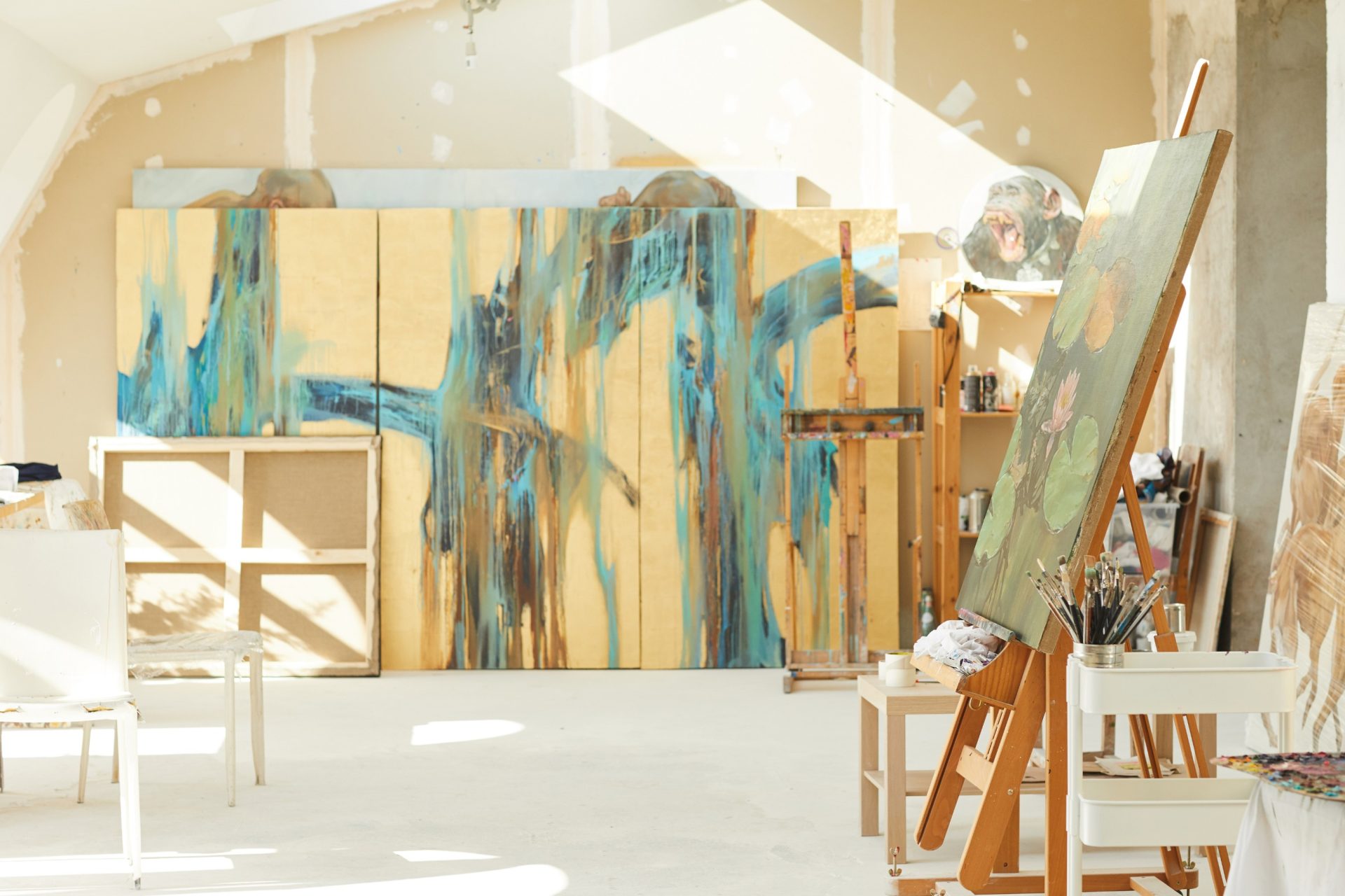 painting studio with large abstract works leaning on the wall.