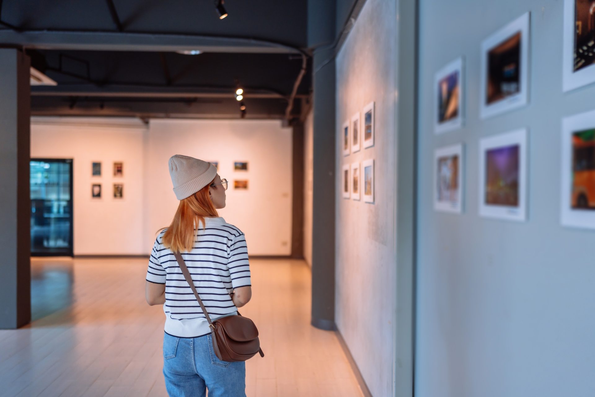 university student viewing an exhibition of the school's art collection