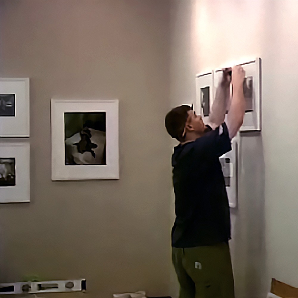 Drew Thomas installing the inaugural Bruce Davidson exhibition at HGG's 57th Street gallery