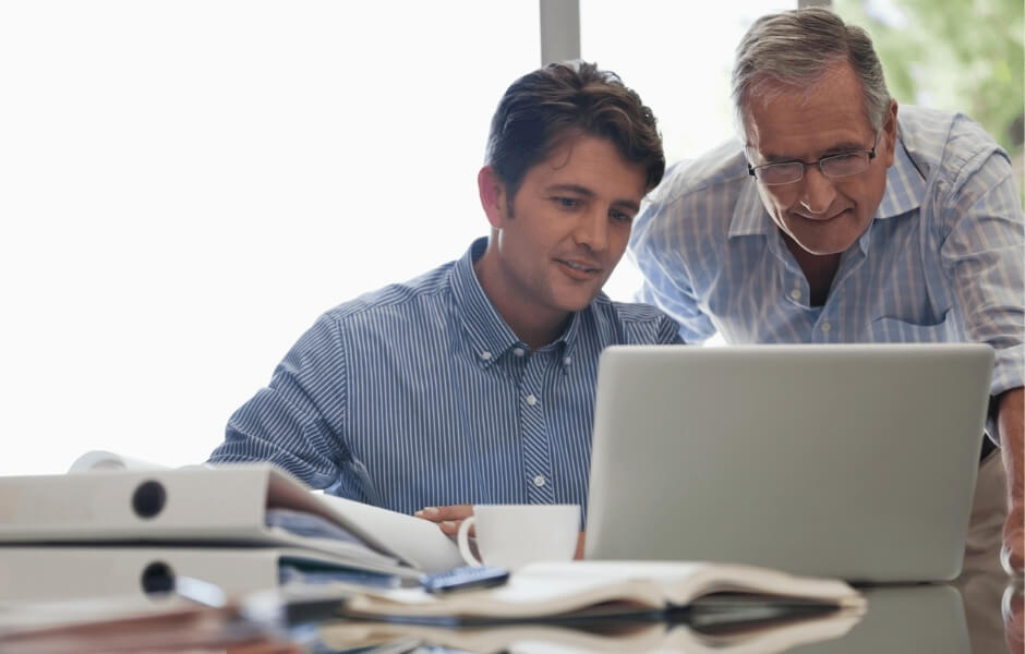 Gallery professionals reviewing collection data on a computer