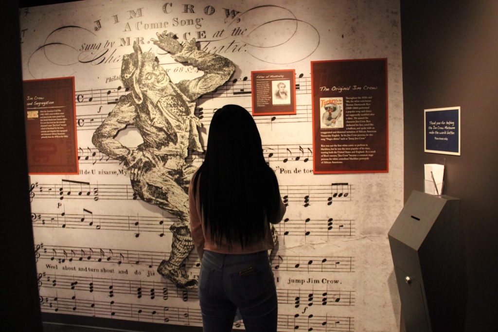 Visitor viewing display wall inside the Jim Crow Museum