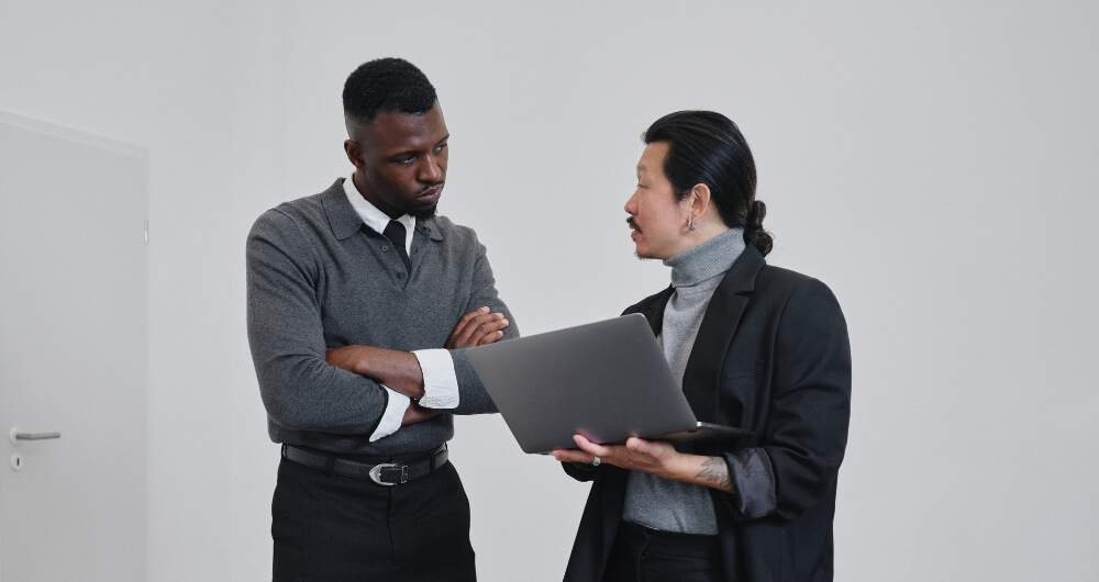 Gallery professionals reviewing information on a computer